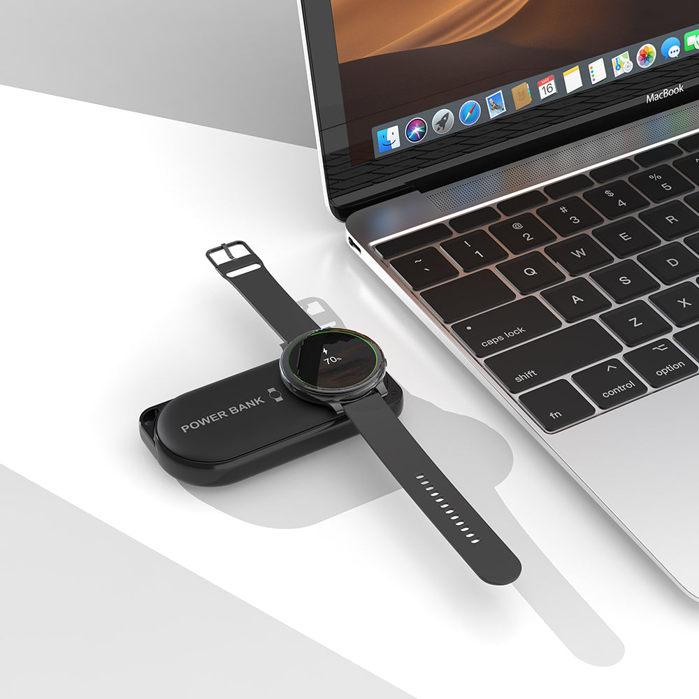 Samsung Galaxy Watch charging next to a laptop on Black iCharger MicroBOOST compact power bank