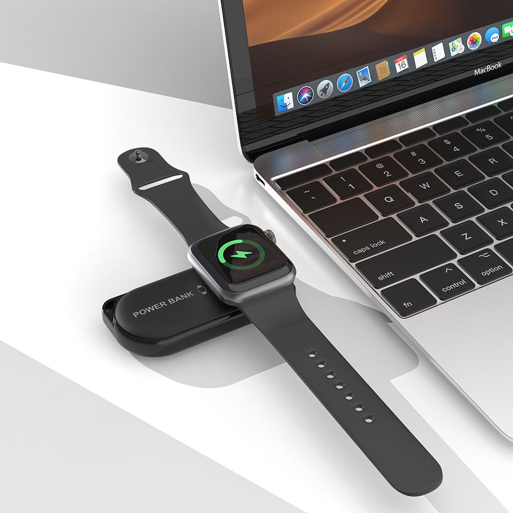 black iCharger MicroBOOST wireless Apple Watch charger next to MacBook for portable charging