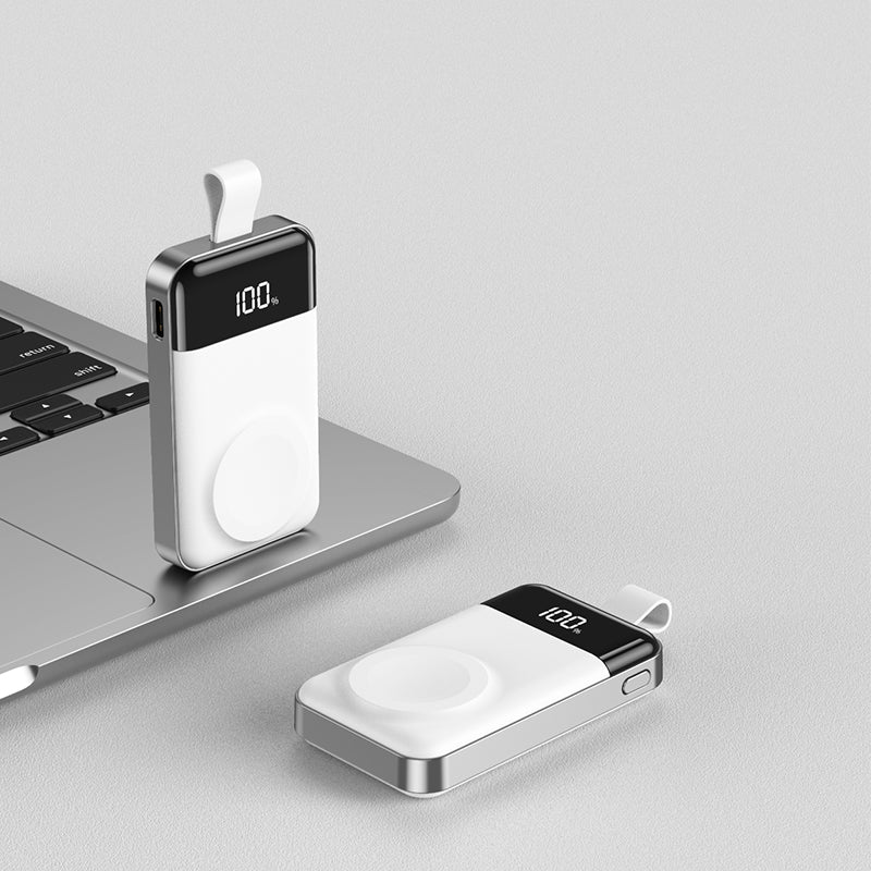 iCharger MicroBOOST Pro for Apple Watch with wireless fast charging, digital display, and portable design, shown near a laptop.